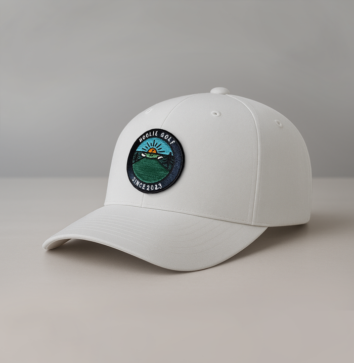 White Early Riser Men’s Golf Hat with sunrise patch and Hoolie pin flag