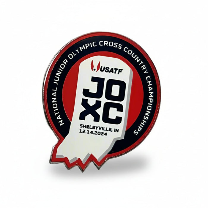 A round red, white, and navy lapel pin with text and logo detailing the 2024 USATF National Junior Olympic Cross Country Championships