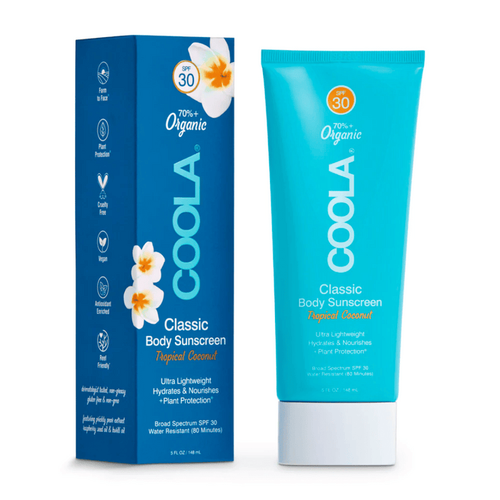 Classic Body Organic Sunscreen Lotion SPF 30 - Tropical Coconut | COOLA in bright blue tube with matching box featuring white flowers, highlighting organic, plant-based, and vegan skincare benefits.