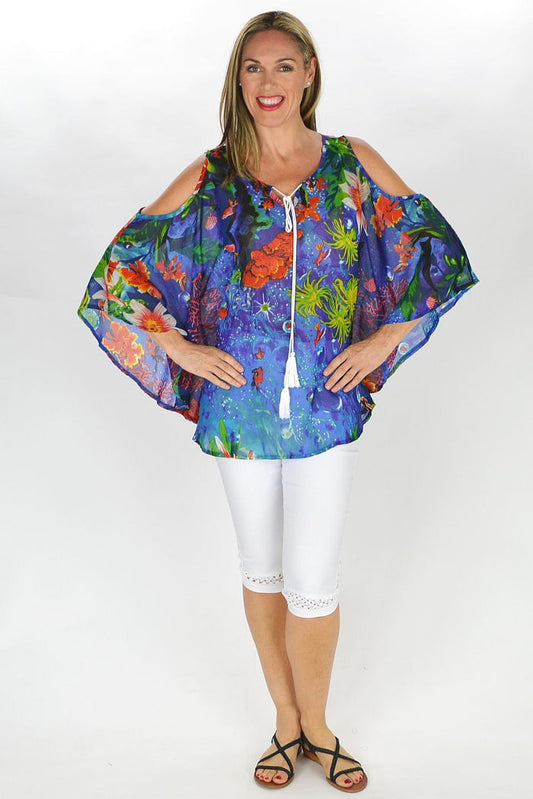 MSTYLE Underwater Garden Tunic displayed on a mannequin, showcasing vibrant floral patterns and flowy fabric design.